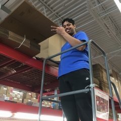 Participant puts away cardboard boxes while working at Staples.