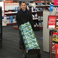 Participant uses a hand truck to move bottle water inventory.