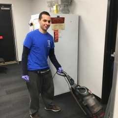 Participant vacuums while working at Staples.