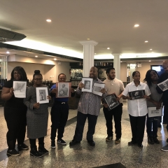 Participants holding up artwork celebrating Black History Month