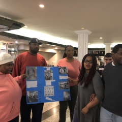 Participants holding up artwork celebrating Black History Month