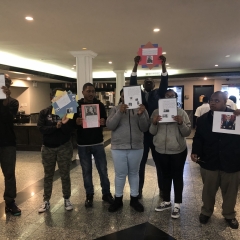 Participants holding up artwork celebrating Black History Month