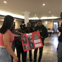 Participants holding up artwork celebrating Black History Month