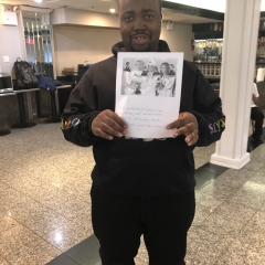 Participant holding up artwork celebrating Black History Month