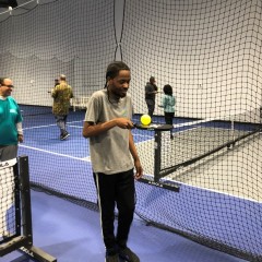 Participant being very steady and careful while walking and balancing the ball on his paddle.
