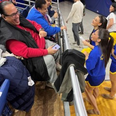 A participant is getting advice about cheering from the Hofstra cheerleaders.