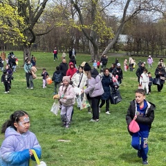Kids running around the field in search of beeping eggs.