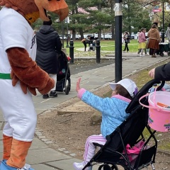 SI FerryHawk's mascot chats with a little kid in a scrawler.
