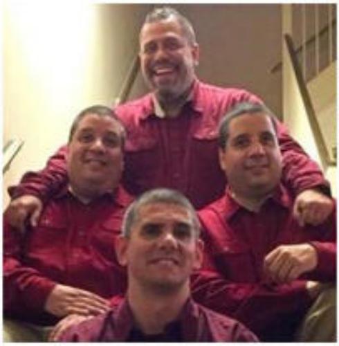 4 men sitting on stairs in red button downs