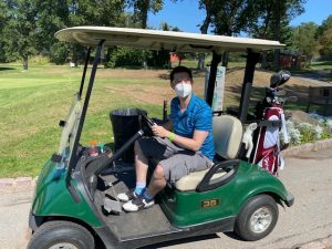 Attendee in a golf cart.