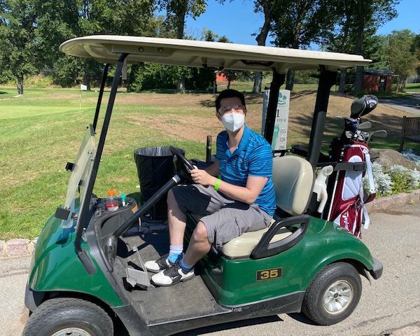 Attendee in a golf cart.